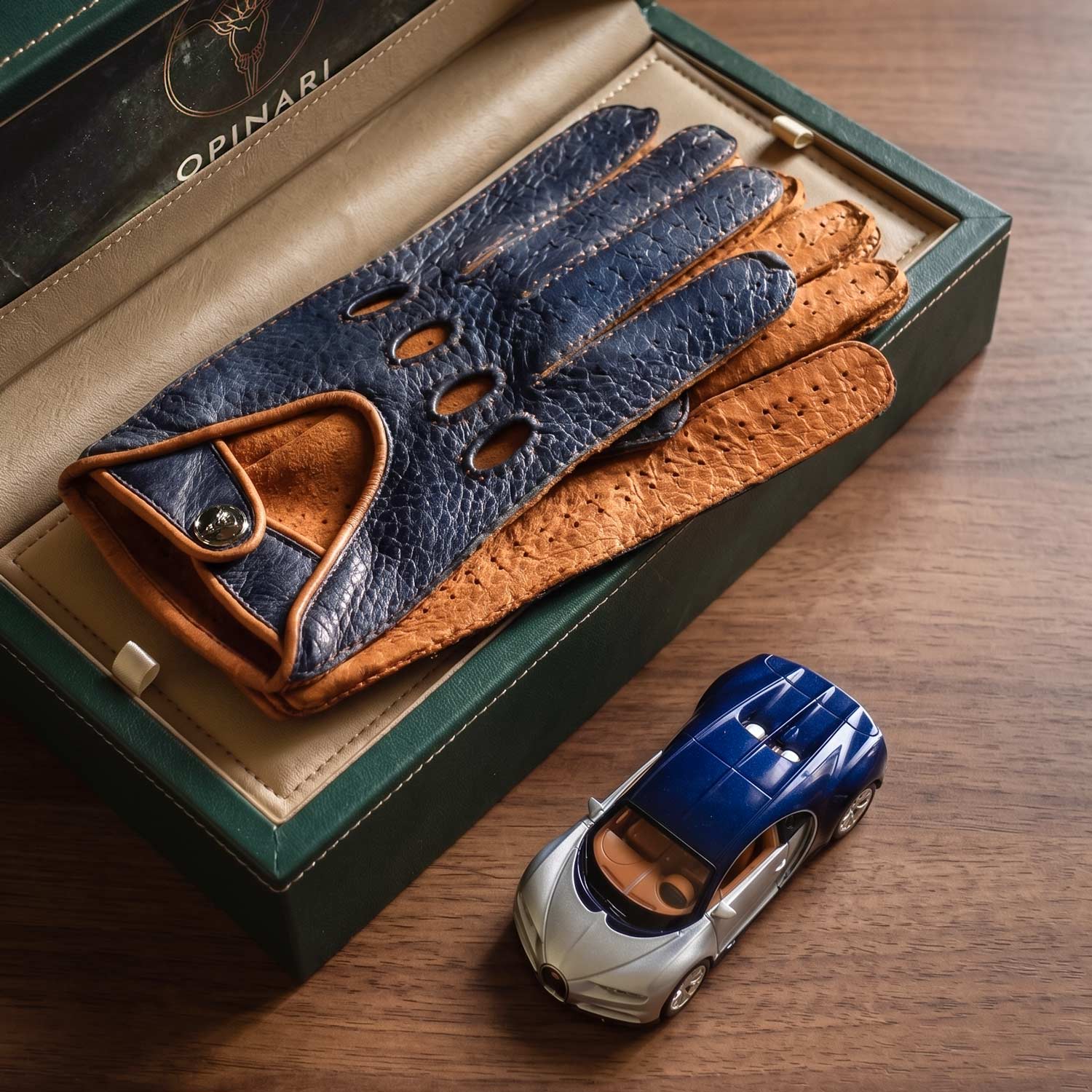 Blue brown handcrafted leather Italian driving gloves, inside a watch box.