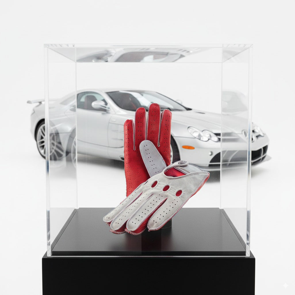 red and suede grey leather driving gloves in front of Mercedes Stirling moss